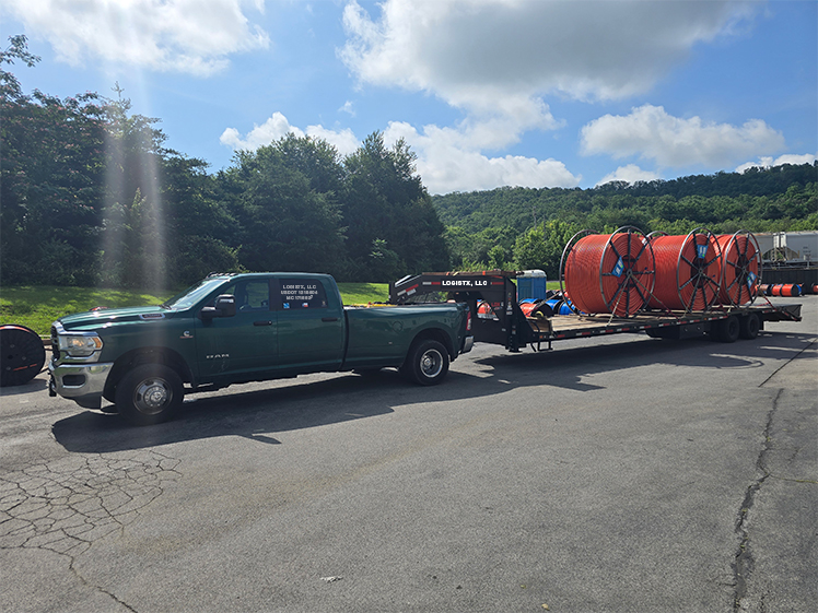 LOGISTX LLC hotshot truck transporting plastic pipe coils